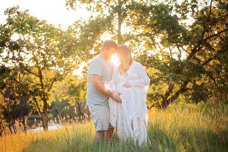 Beautiful sunset image of an expecting couple.