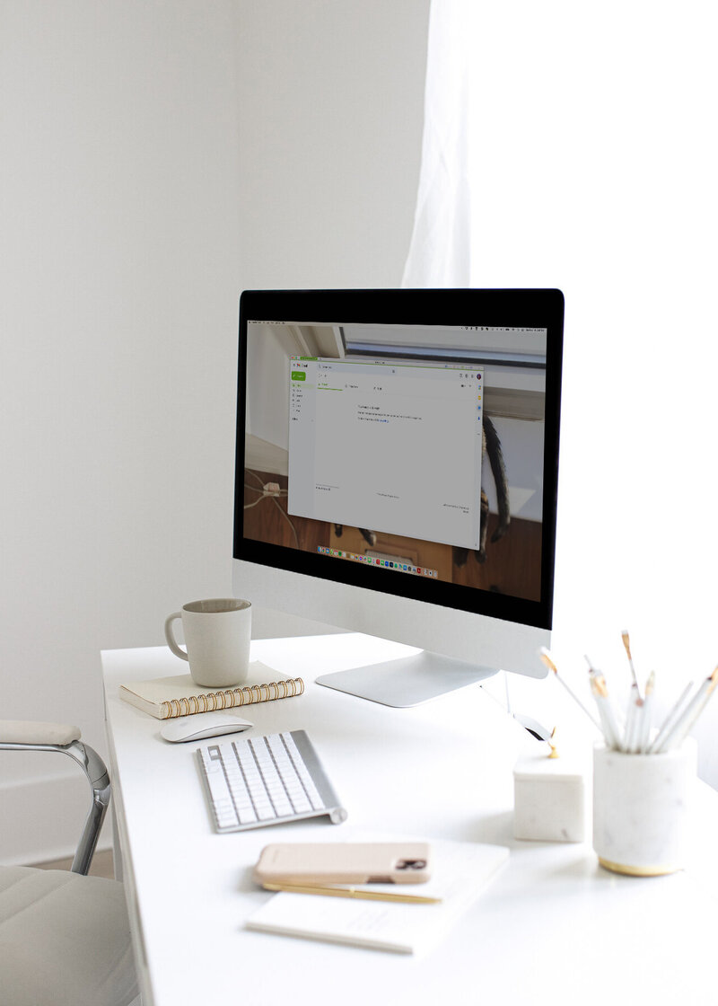 Desk with computer showing gmail