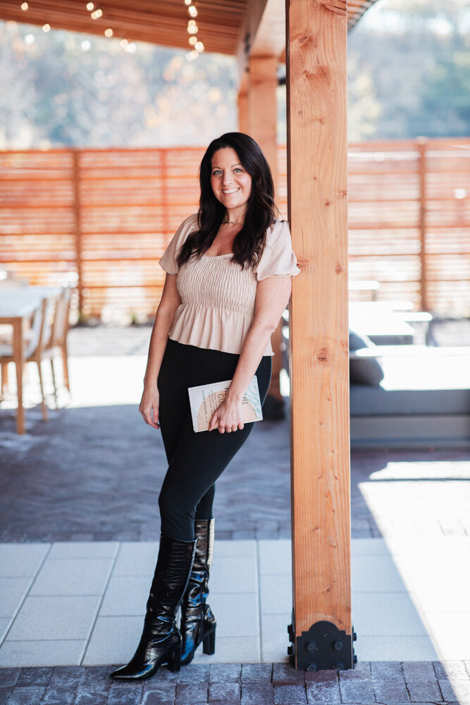 Alison Seponara leaning against a cedar post