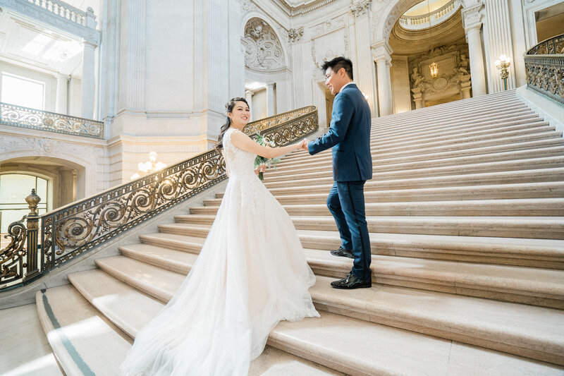 white wedding dress on grand staircase at san francisco city hall wedding