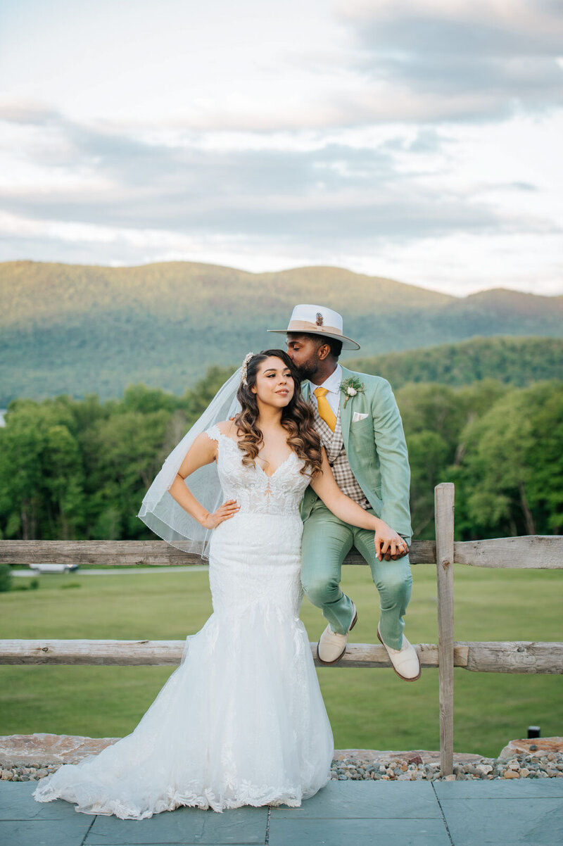 stylish bride and groom in front of mountain sunset at mountain top inn in chittenden vermont