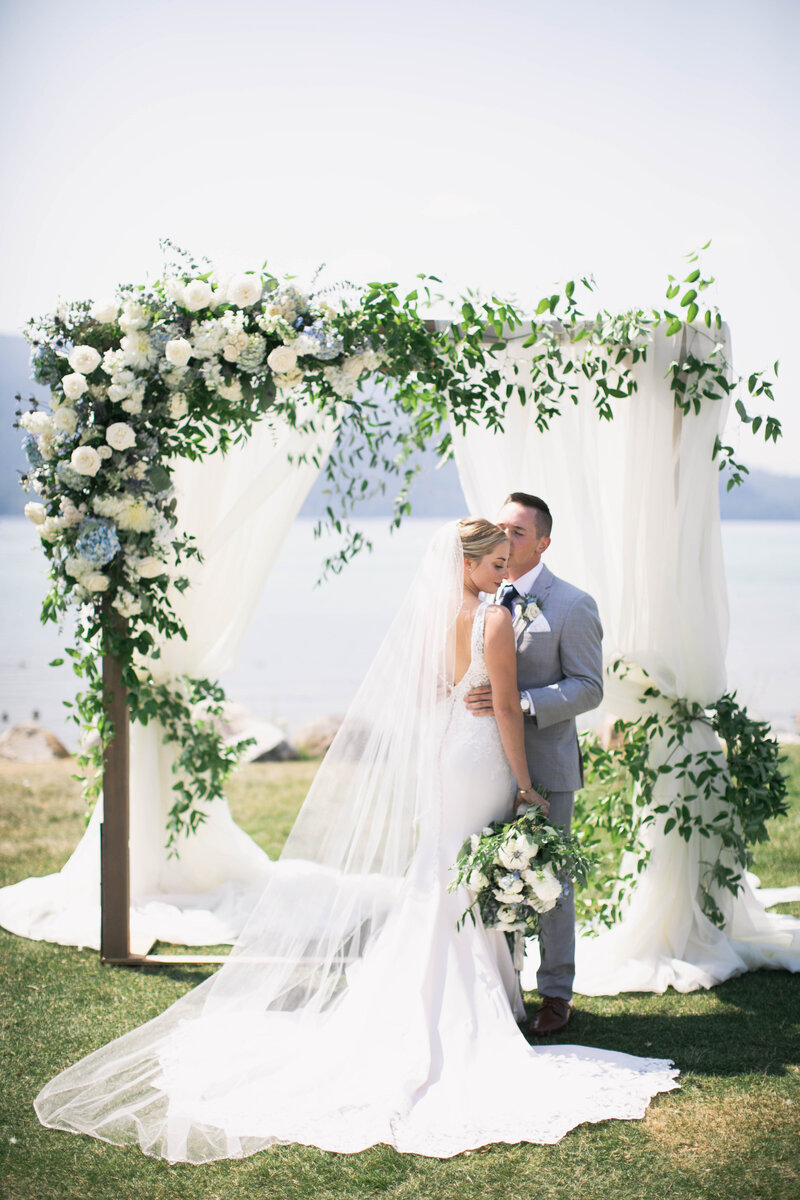 groom kissing bride on forehead