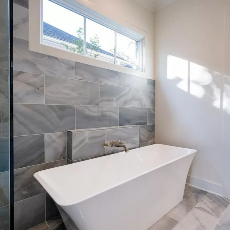 Gray marble-like wall tile with blue undertones in a bathroom.