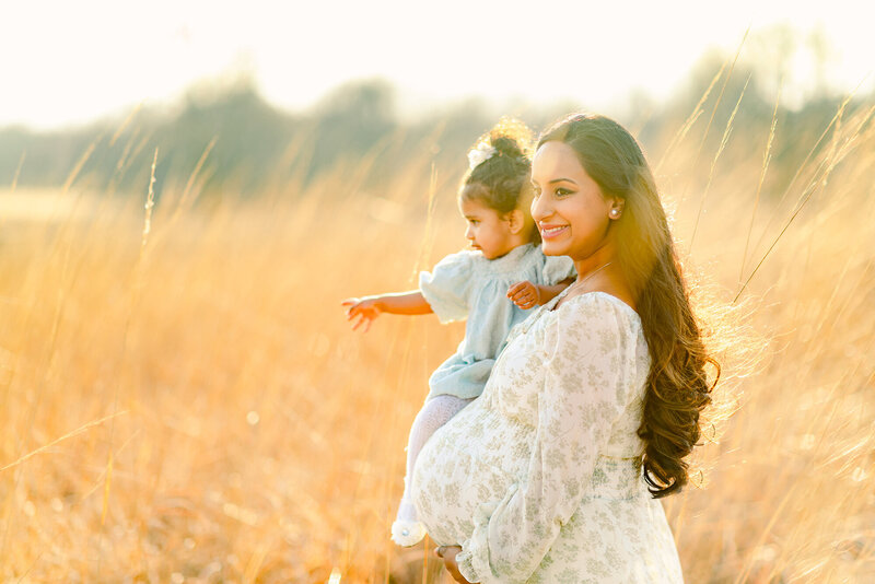 Maternity portraits of a woman holding her toddler daughter by Chicago Portrait Photographer Kristen Hazelton