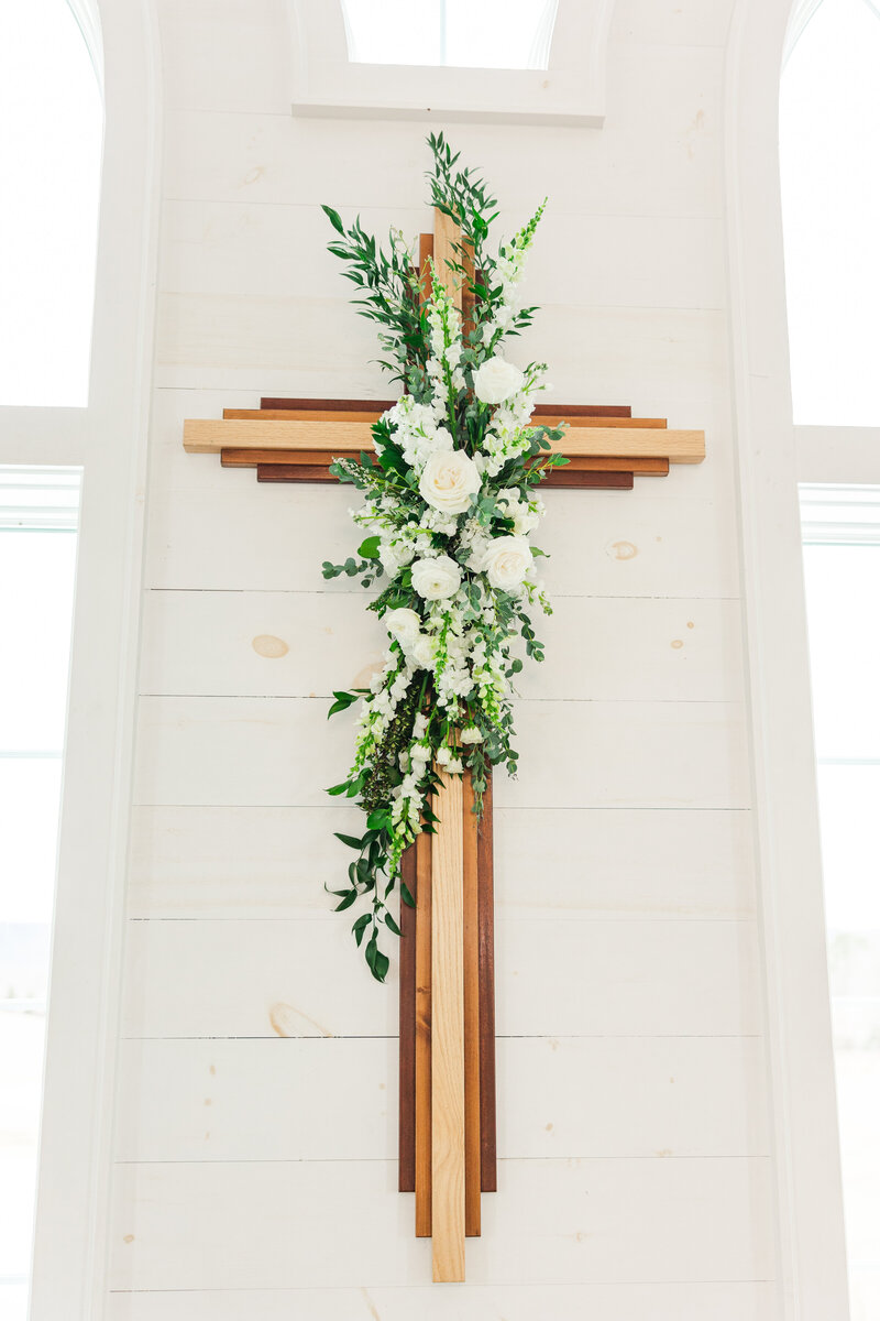 a wooden cross hanging in a chapel