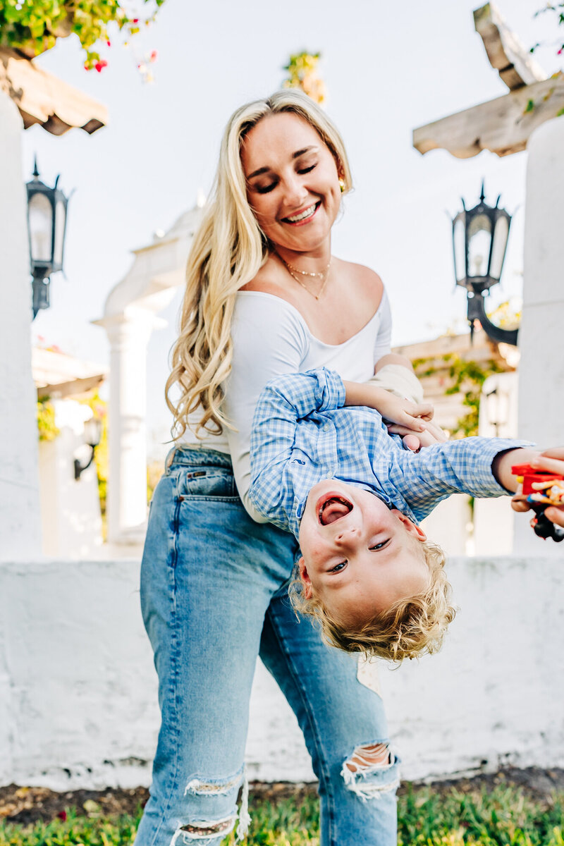 Cozy family moments during holiday mini sessions near bougainvilleas and waterfront views.