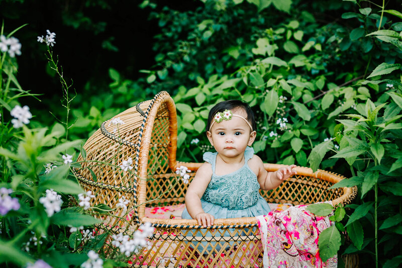 baby in boho basket in the forest