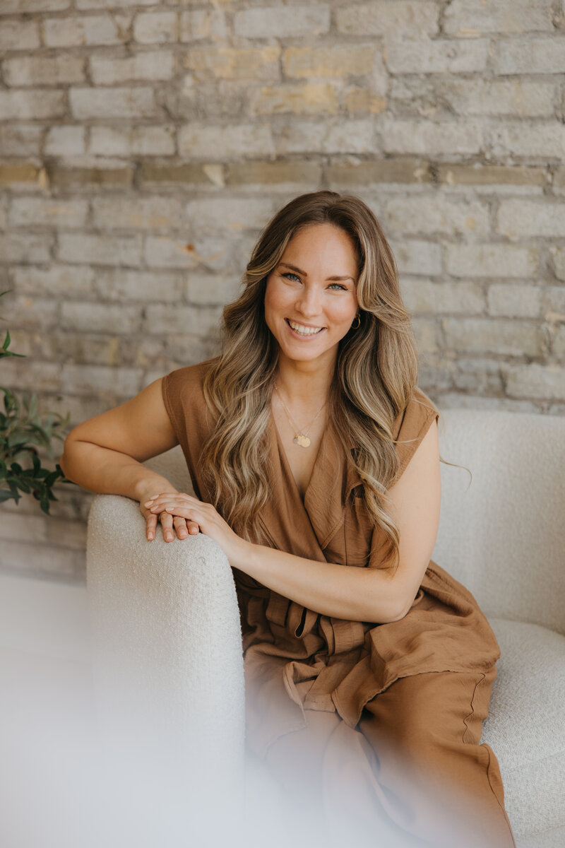 Christine Poulin Sitting in chair looking calm and happy