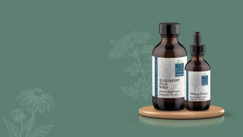 Two herbal dietary supplements, Elderberry Plus Syrup and Female Tonic, from Wise Woman Herbals are displayed on a green background with botanical illustrations.