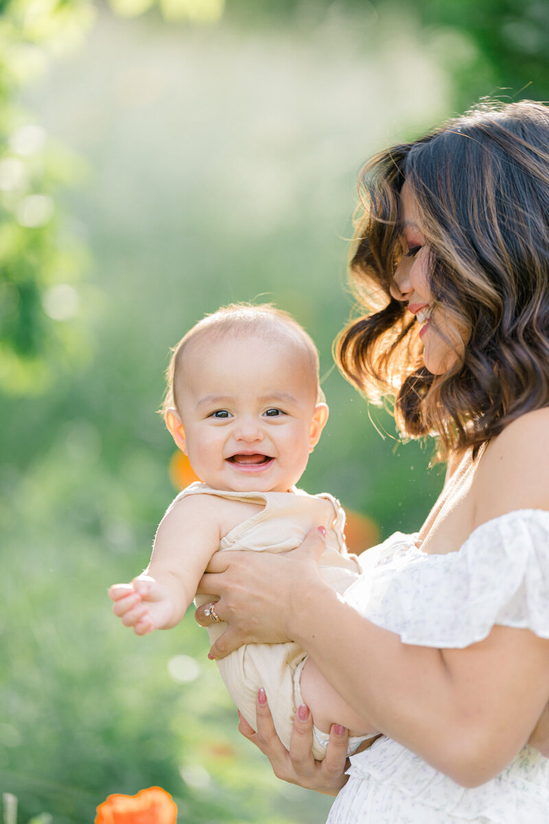 mother holding smiling baby