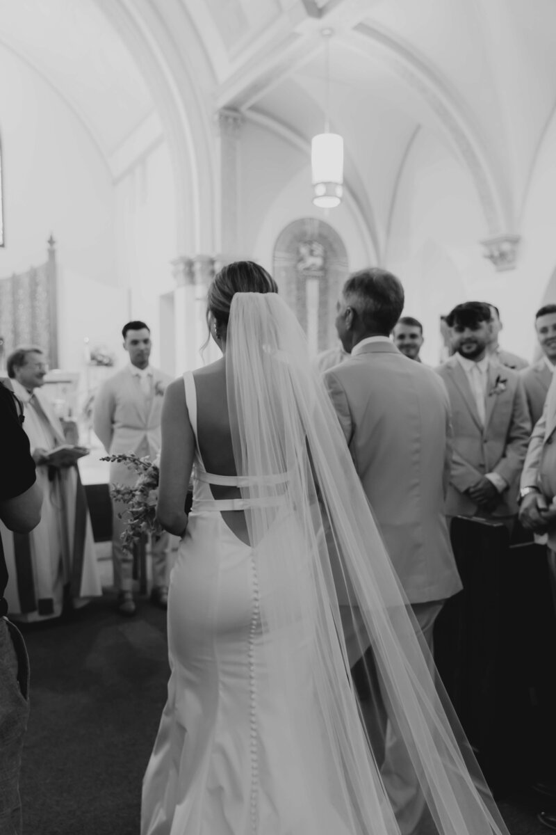 Bride walking down the aisle in emotional church ceremony, timeless and candid storytelling for modern Ohio wedding couples