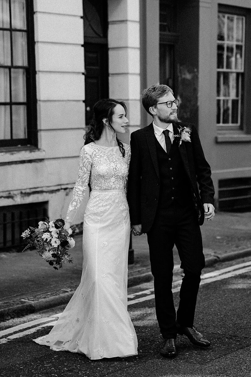 bride and groom looking away at london wedding venue