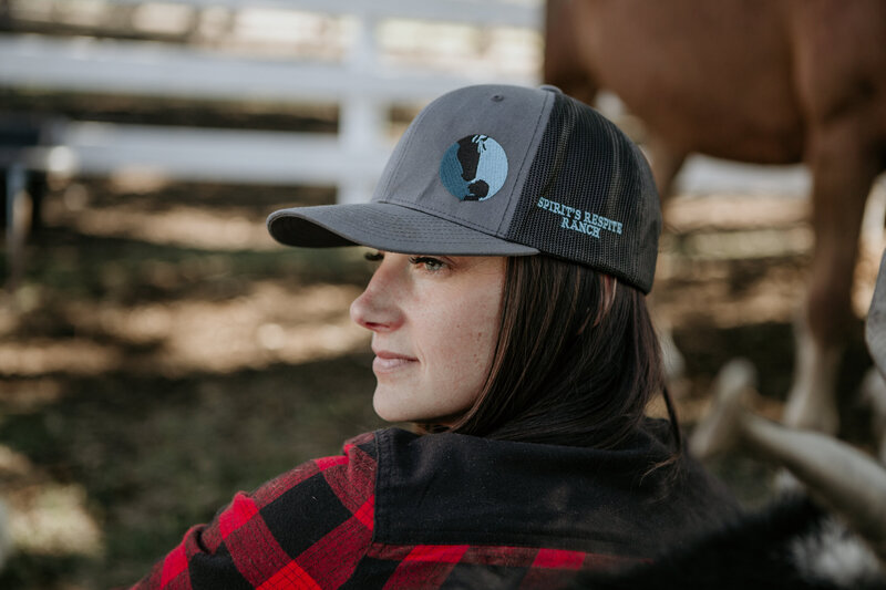 Close-up shot of Janelle Robinson, founder of Spirit’s Respite Ranch, wearing merchandise that helps fund the ranch's programs and support the care of the animals