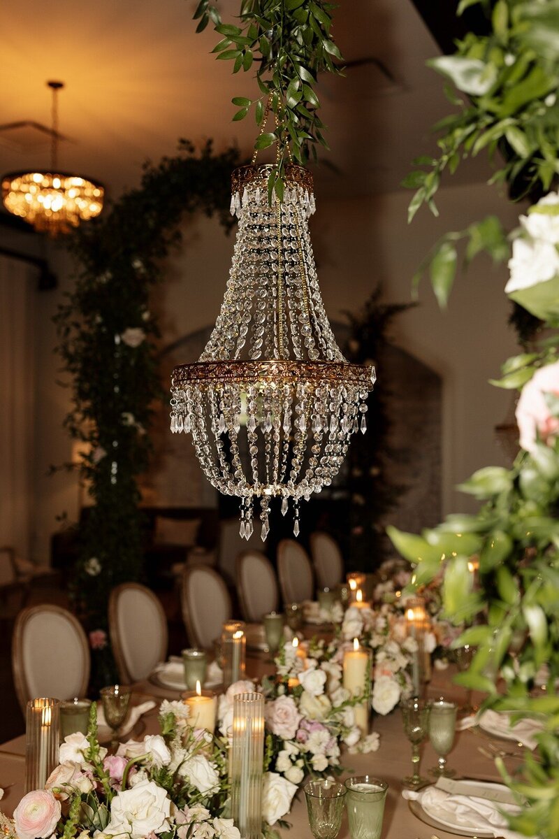 An elegant indoor wedding reception with a stunning chandelier at Grbic Events, a wedding venue in St. Louis.