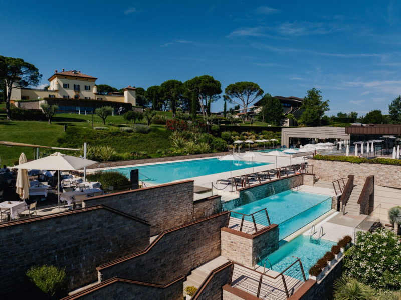 Terraced pools and gardens at Palazzo di Varignana Resort & Spa near Bologna, Italy—a luxurious wellness retreat featured on the Wish You WERE Here Italy Tour with author Christy Schillig.