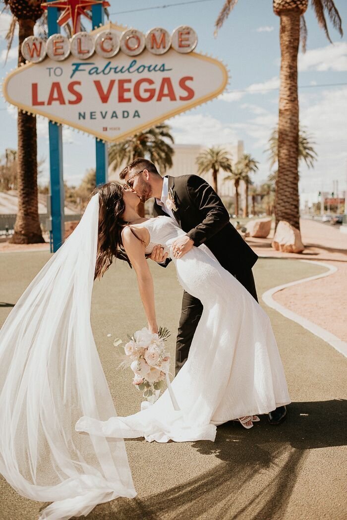Couple saying ‘I Do’ under neon lights Las Vegas wedding