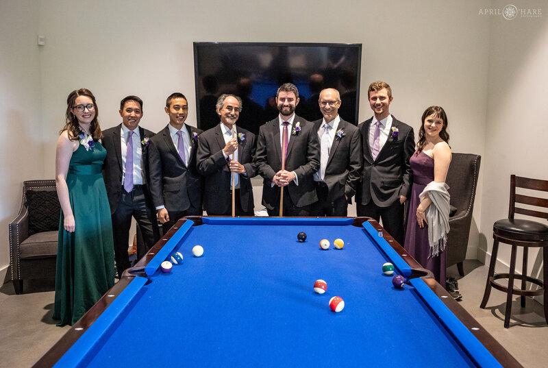 Groom Hanging out with Friends around the Pool Table at The Woodlands Wedding Barn in Colorado