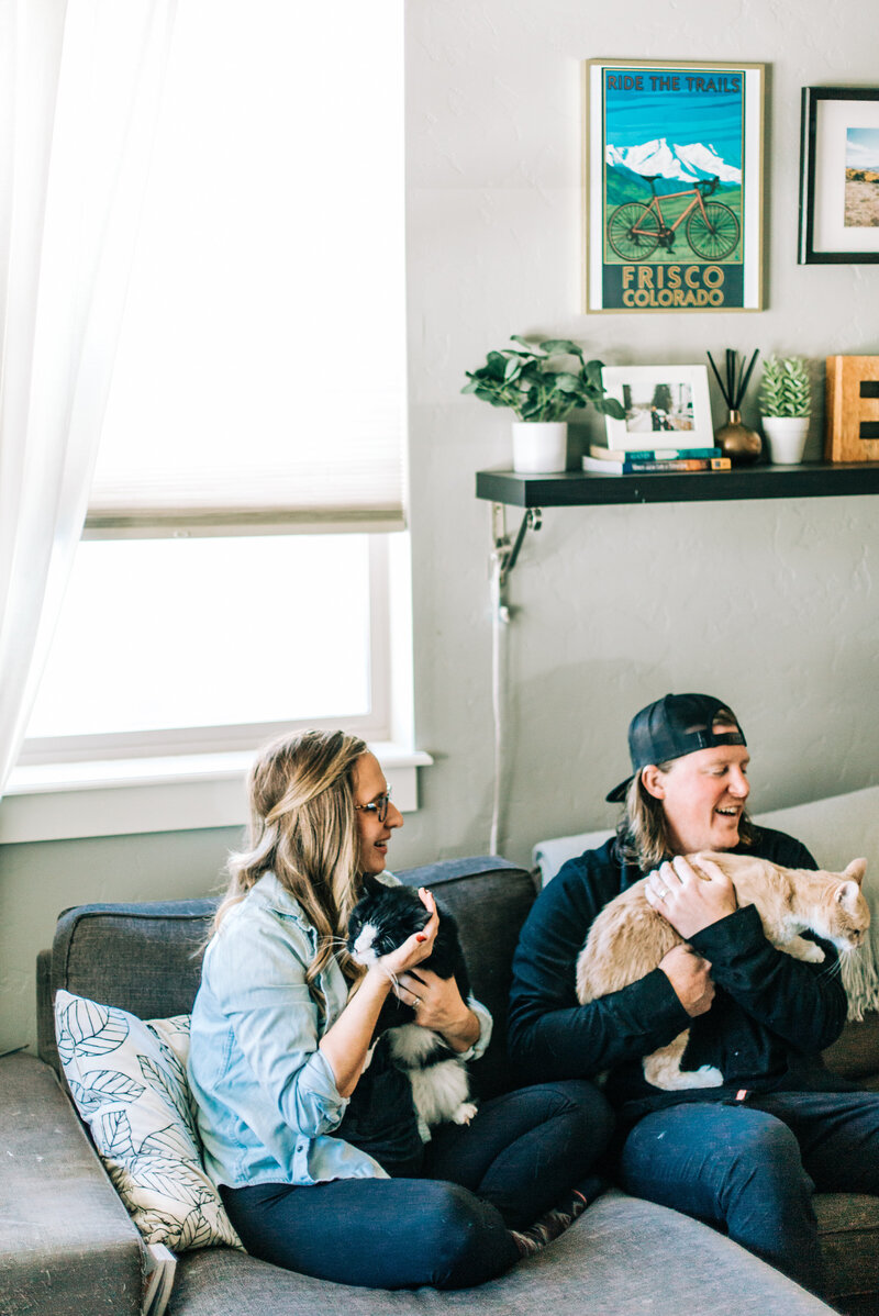 photo of couple snuggling their cats