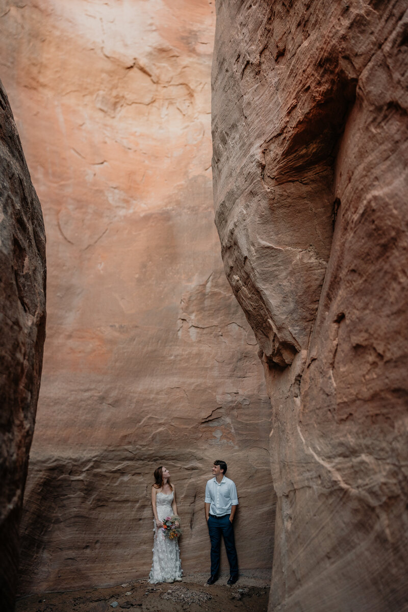Couple stands in slot canyon on their elopement day. 
