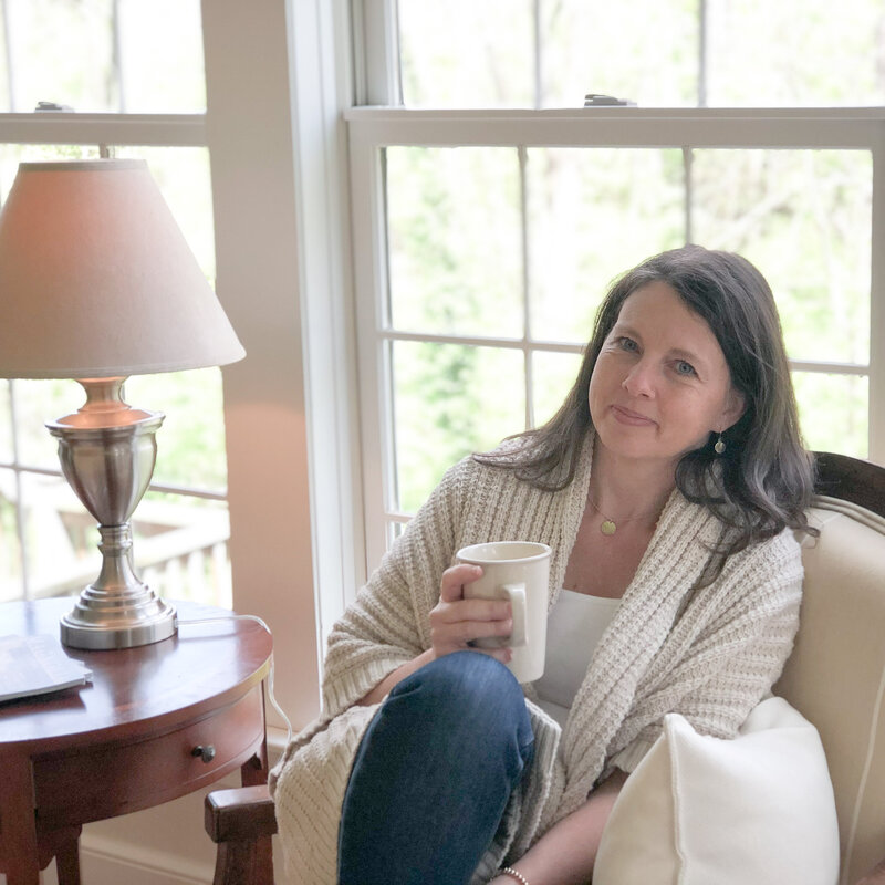 Rachel Sanford in tan sweater seated with warm mug