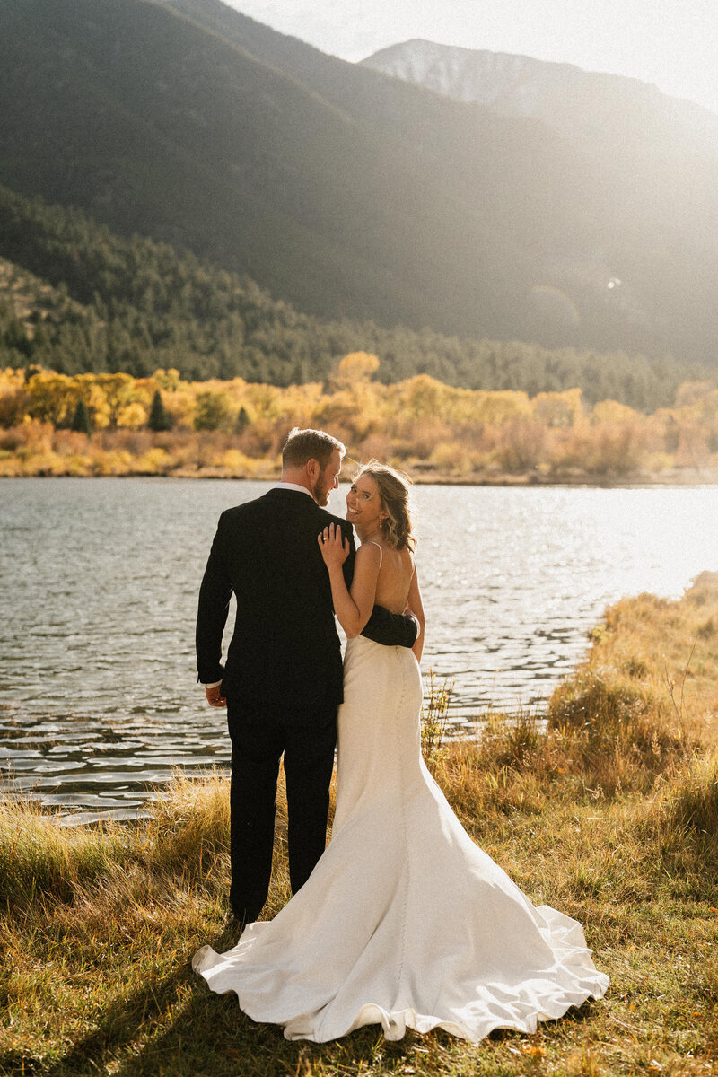 Couple holding each other with boho wedding flowers in Colorado