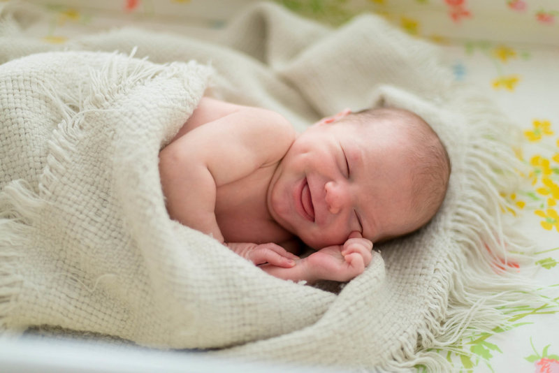newborn baby girl smiling