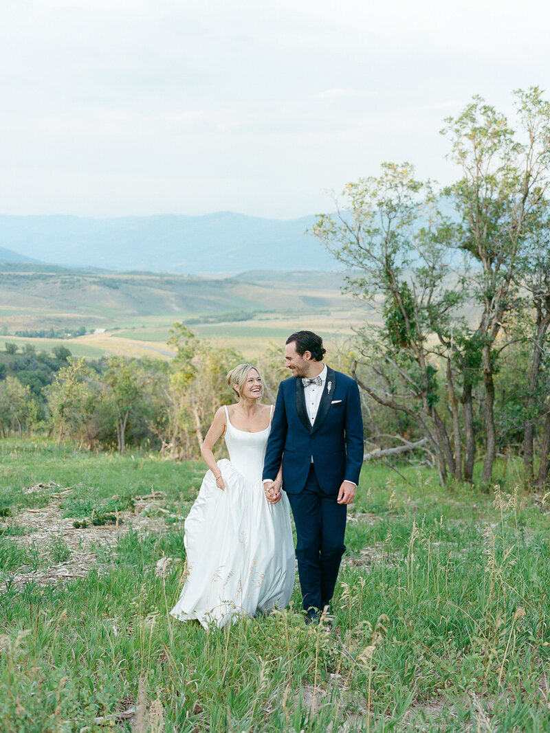 Couple walking in a field for Boulder wedding