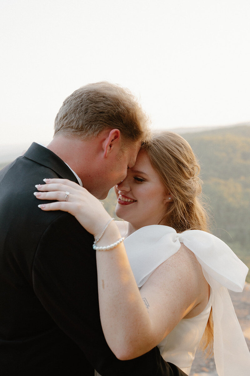 photo of a couple eloping on a mountain in black tie attire