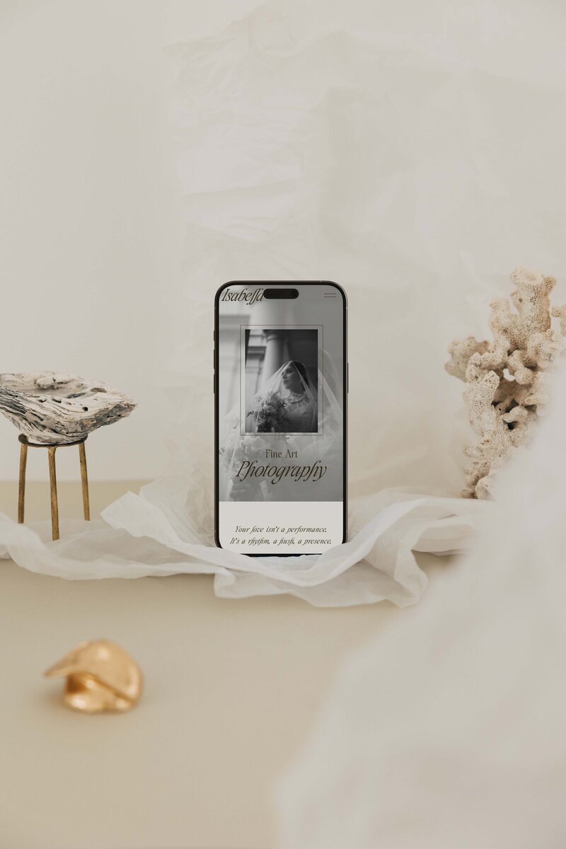 Minimalist mobile mockup of a fine art photographer’s Showit site, styled with soft textures and coastal elements—highlighting The Closers Society’s Website in a Day service for refined, mobile-first design.