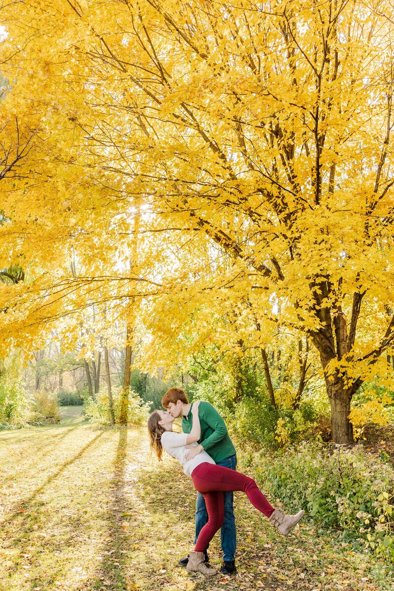 Minooka Park golden light golden leaf tree dip kiss. Engagement couple. Engagement photoshoot Waukesha Wisconsin.