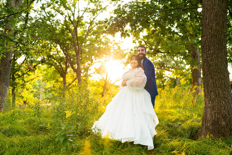 Bride and groom snuggle on their wedding day.