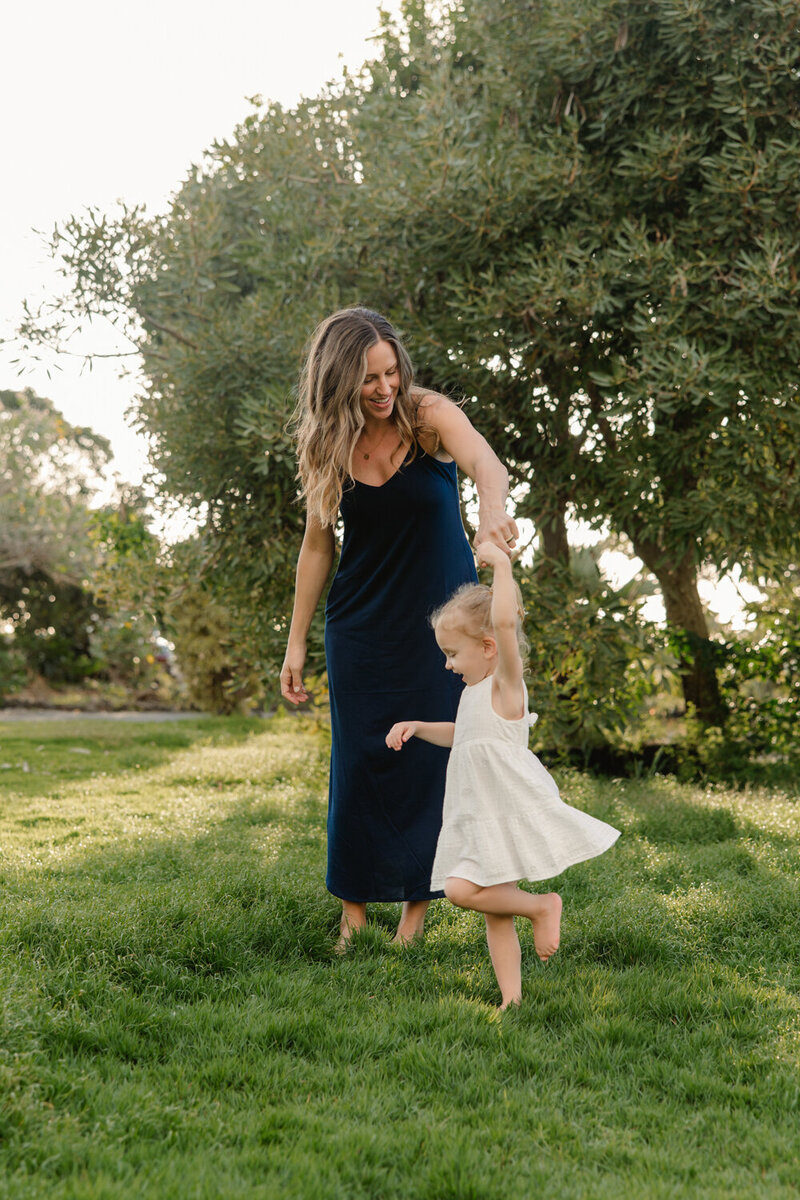 mom twirling little girl