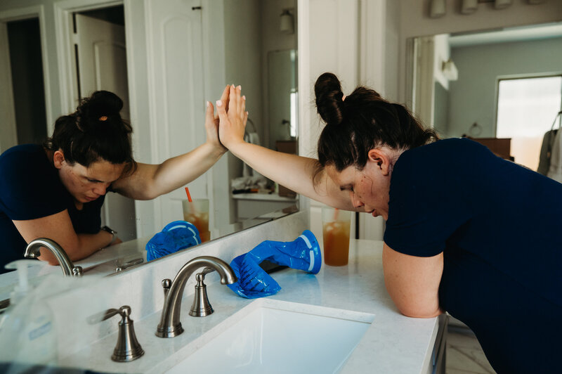 Mother laboring in a birth pool with support from her partner — emotional home birth photography in Aledo by Poppy + Blue Photography
