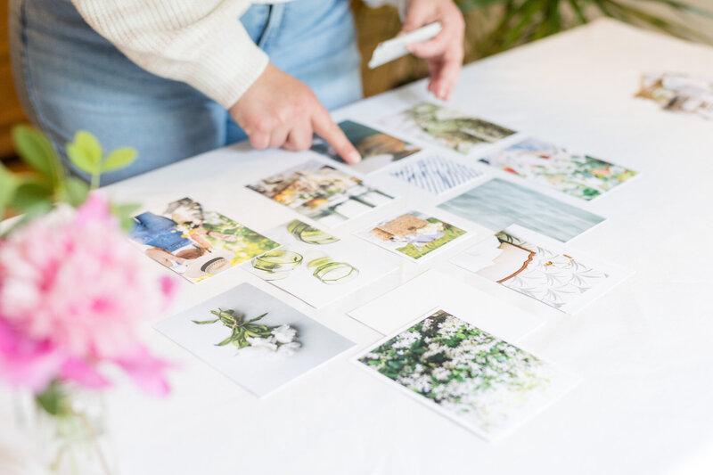 Aubre curating a mood board of photographs and color swatches