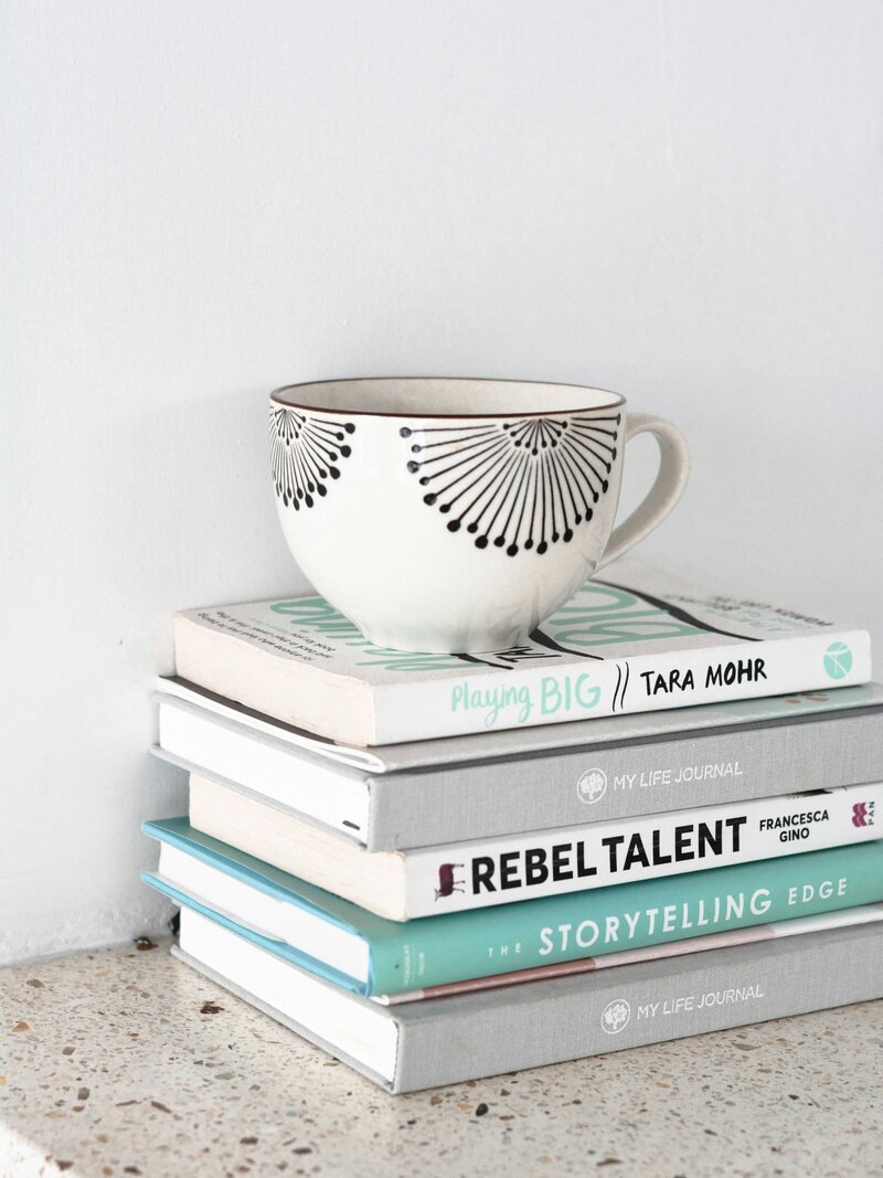 Image of business books focused on professional development and coaching. Creative Dynamics recommends essential reading for entrepreneurs and business professionals looking to enhance their skills and knowledge. Image credit: Unsplash.