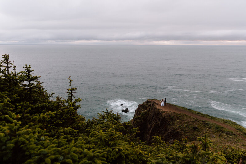 Elopement couple on a cliff outcrop on the Oregon Coast.