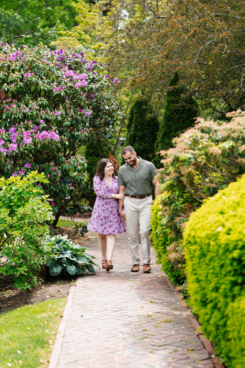 Romantic Lynch Park engagement photos in Beverly, MA by Danielle Littles Photography. Natural, candid moments captured in a stunning garden and coastal setting.