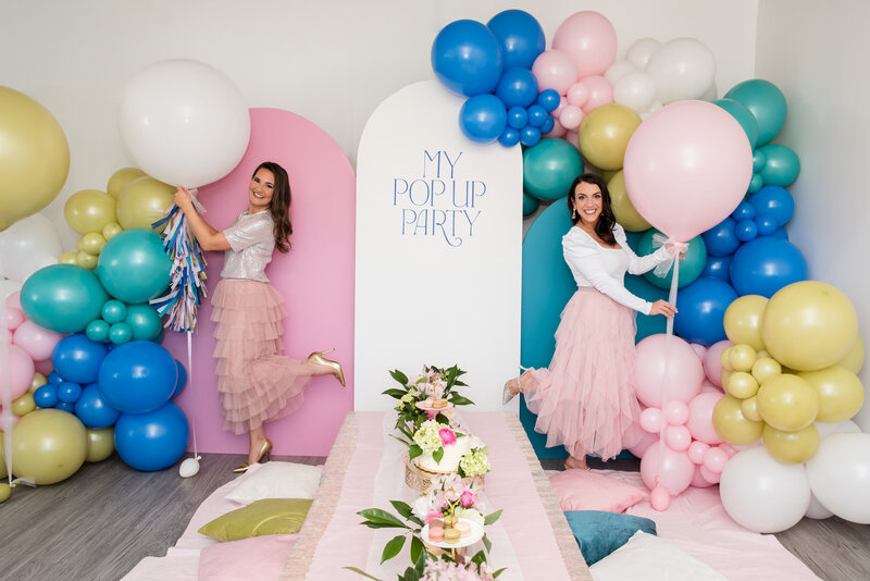 Female founders on green couch, party styling for kids and adults in Pittsburgh, Pennsylvania.