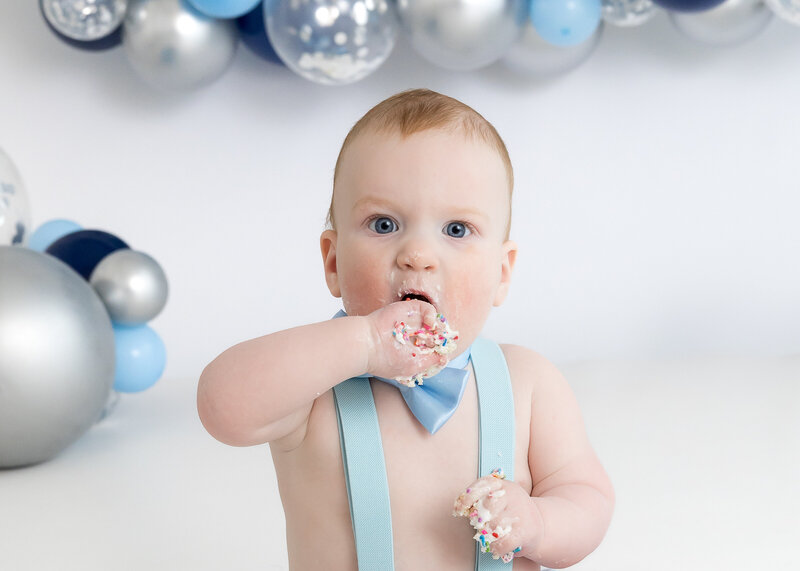 Light and airy lifestyle portrait of a baby at a 1st birthday cake smash photo session at Allison Reilly's Union County, NJ photo studio.