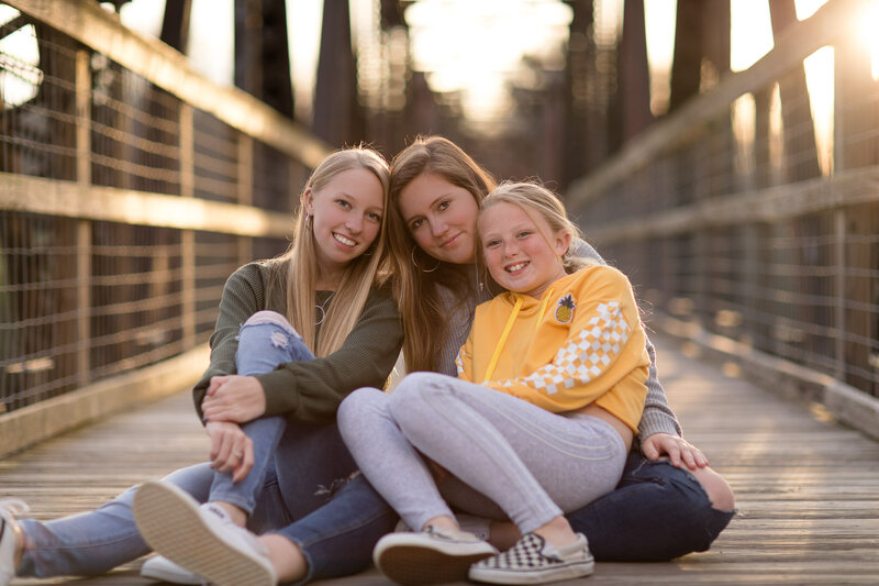 a family taking portraits on a bridge in Columbia, SC