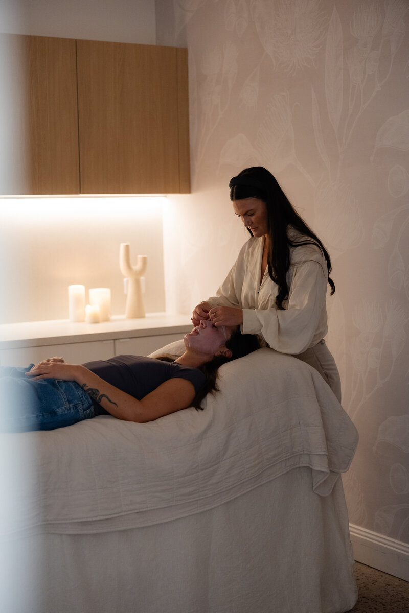 Cosmetic nurse performing exomide and rejuran treatment on client in treatment room in newcastle NSW