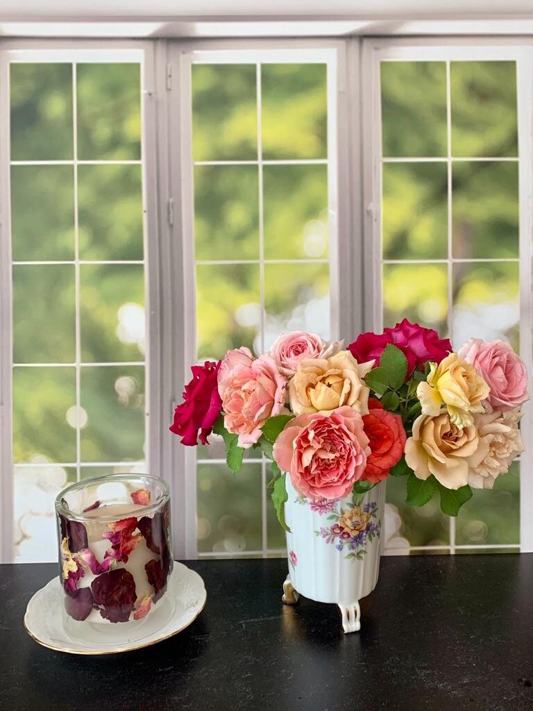 roses and candle in window