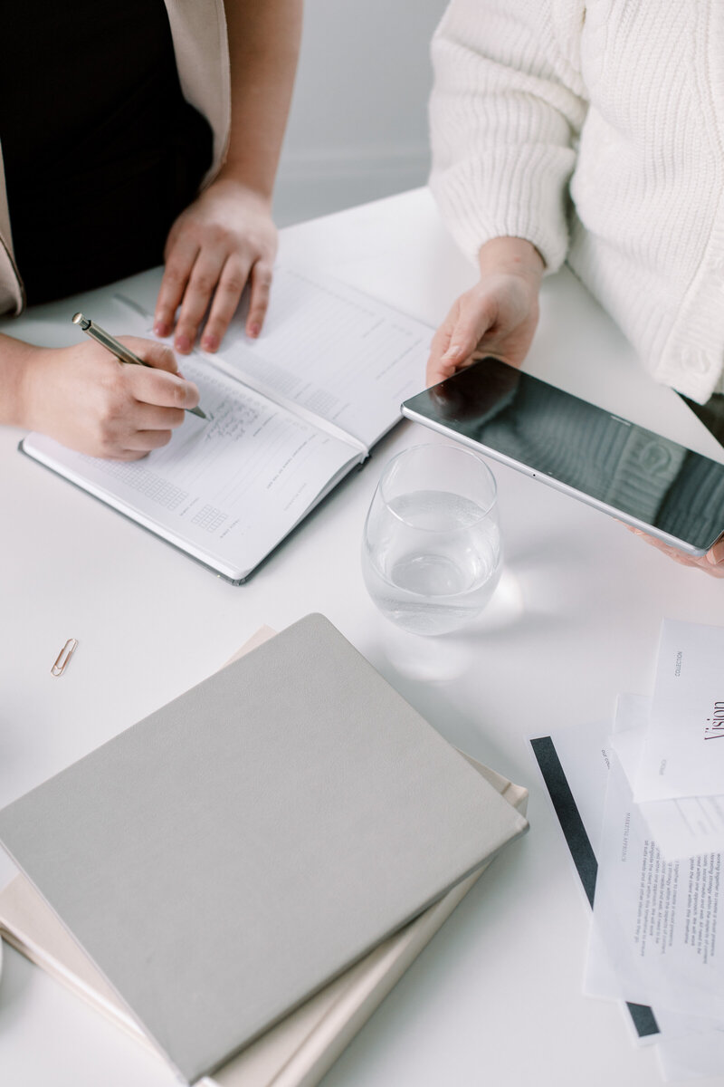 Photo from above of woman opening her laptop with coffee cup