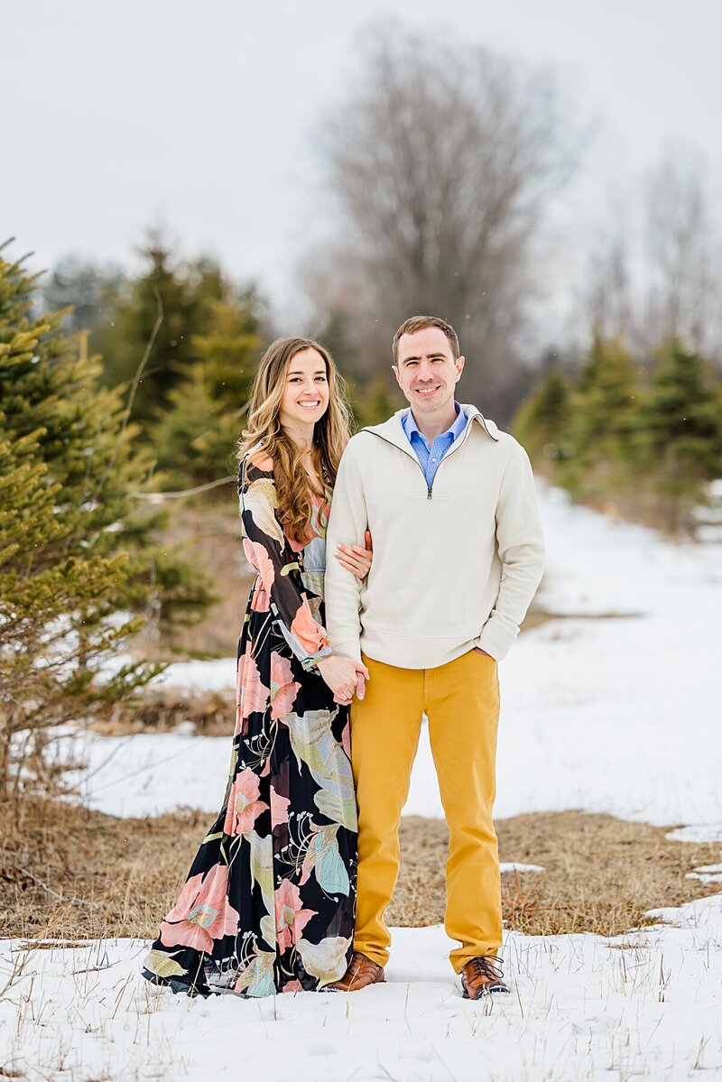 couple-holding-hands-in-tree-farm