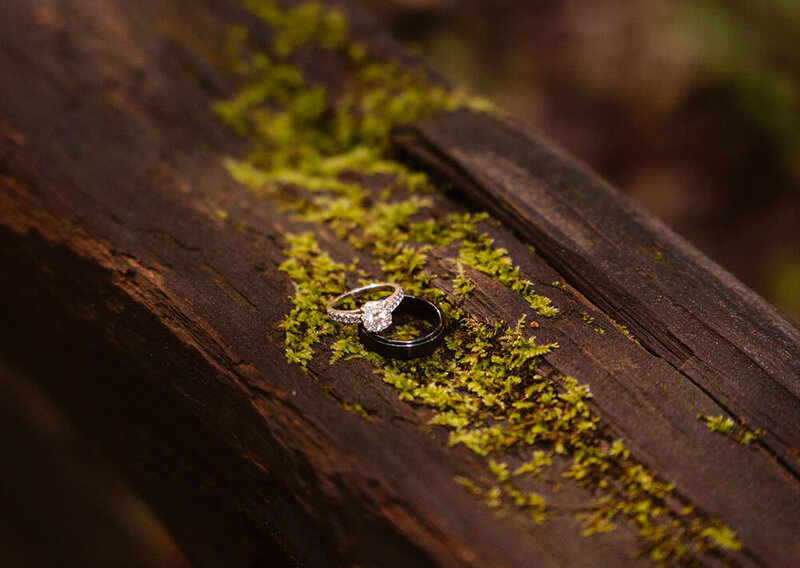 Two people standing in muddy wedding attire during their Henry Cowell redwoods elopement.