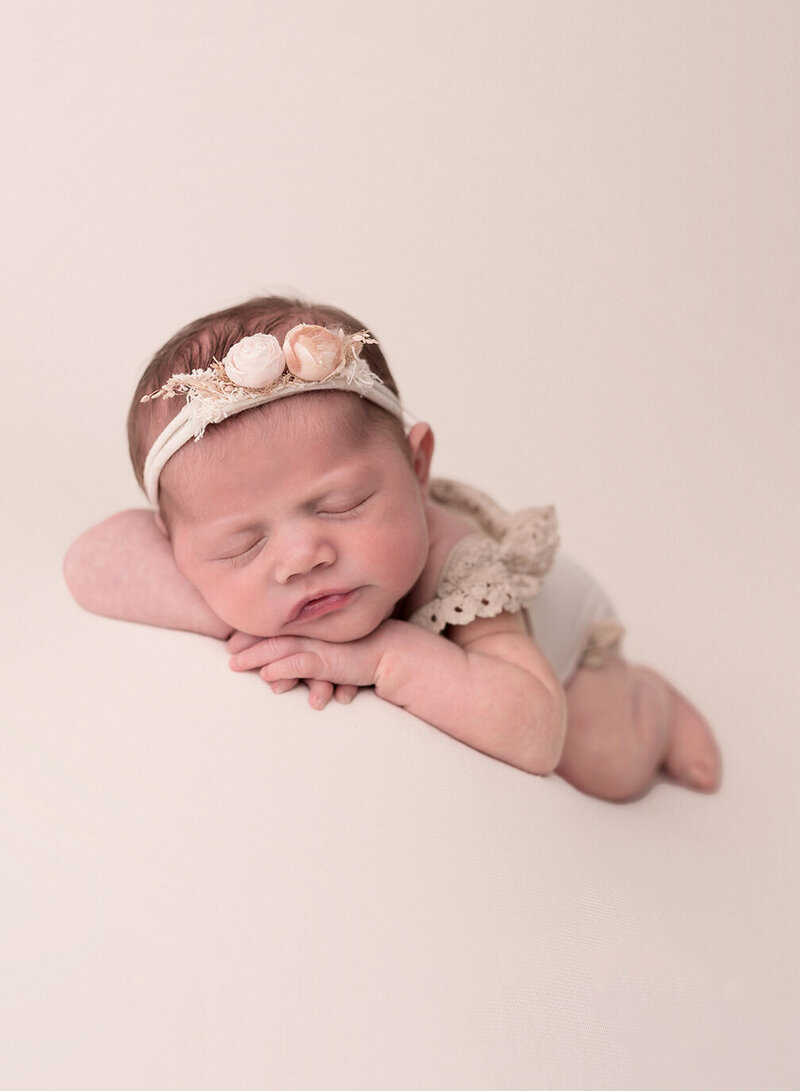 Newborn baby girl sleeps sweetly during her St. Louis newborn photo session