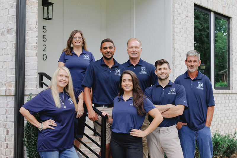 Team photo of Hallmark building group in driveway of new home
