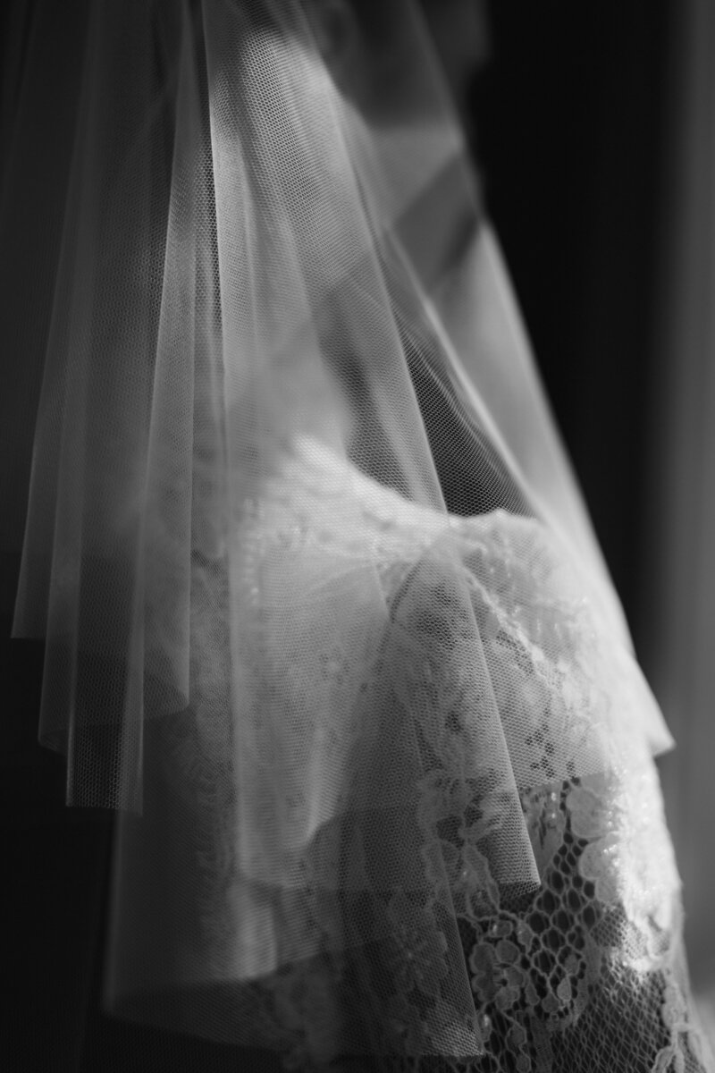 elegant black and white editorial wedding photo of bride by window with luminous light by Nicola Hudson from Adorlee weddings in London