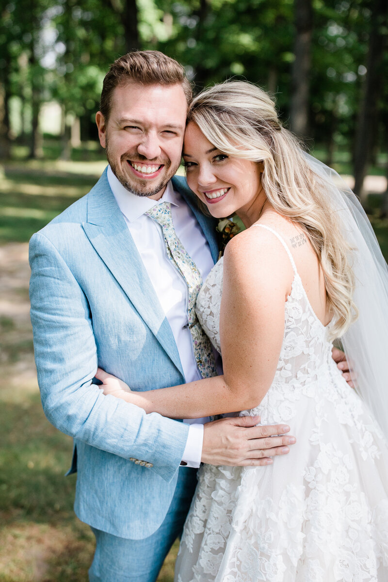 Bride and Groom snuggle and smile