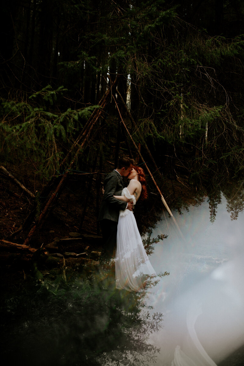A couple in the woods kissing